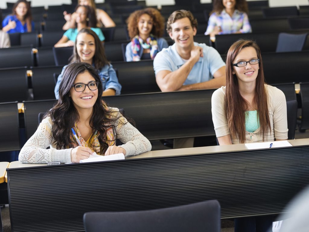 Large group of students listening to teacher in lecture hall 000050987518 Large