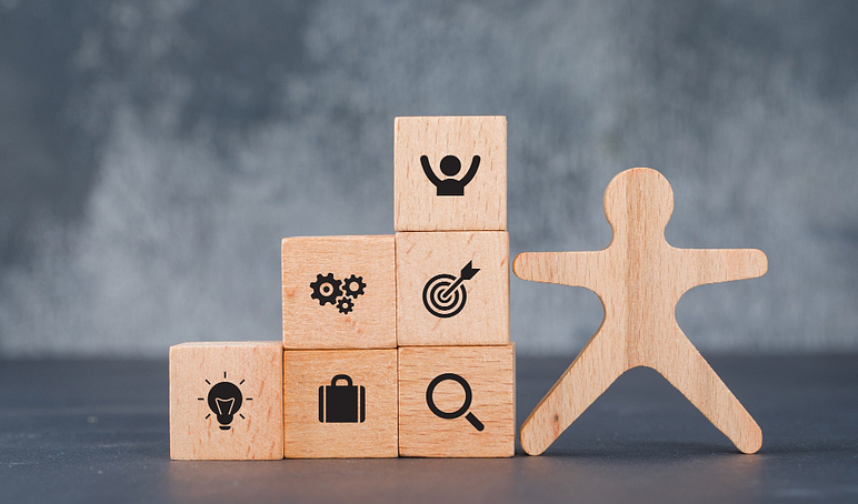 Conceptual success target with wooden human blocks