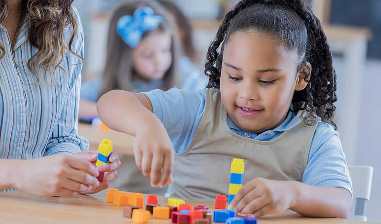Elementary girl using manipulatives